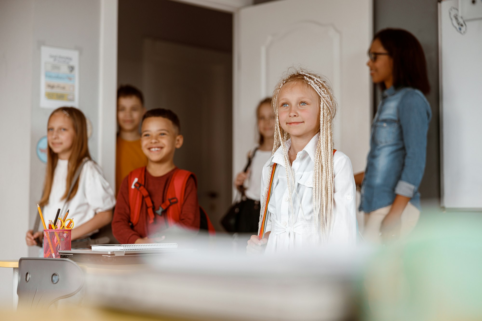 Happy children standing in class at school