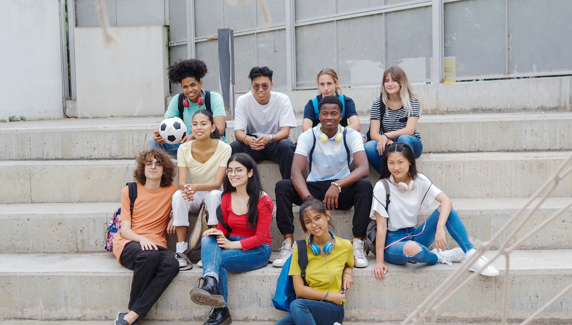 Group of diverse teenage students in the schoolyard.